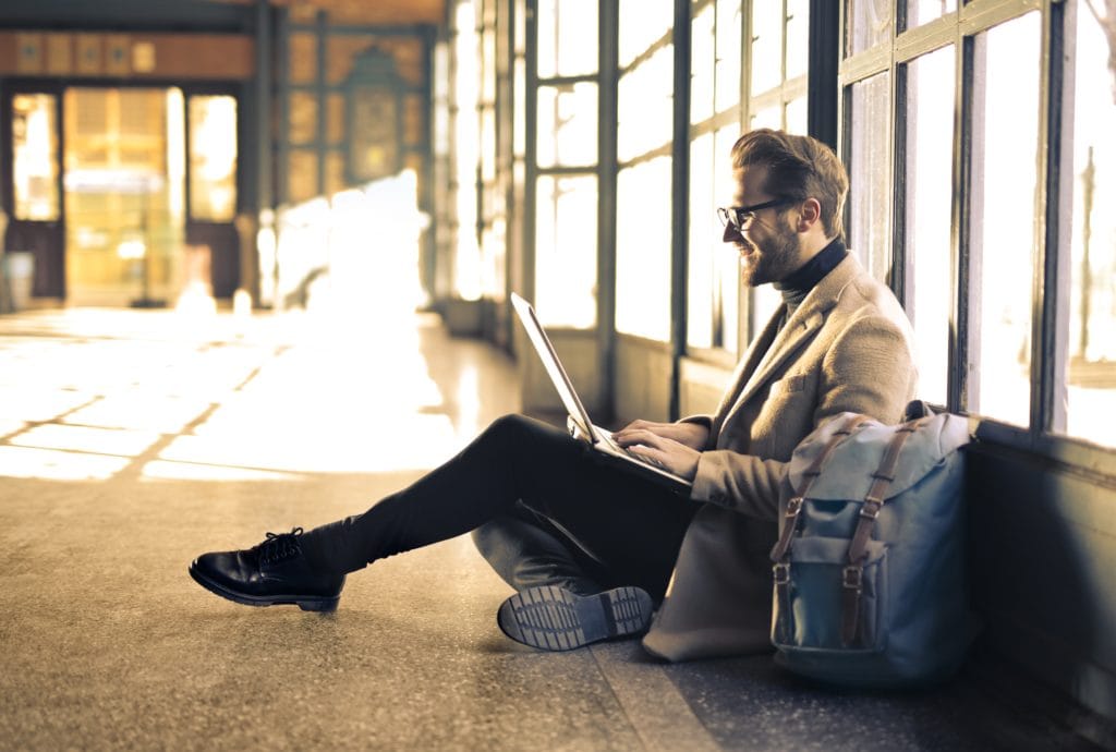 Man working with his laptop on the floor.