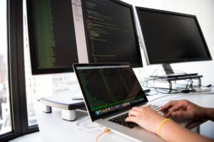 Coder writing on multiple screens
