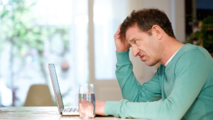 confused man looking at laptop screen
