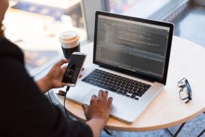 Developer working on laptop and phone