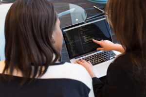 Women coding in laptop