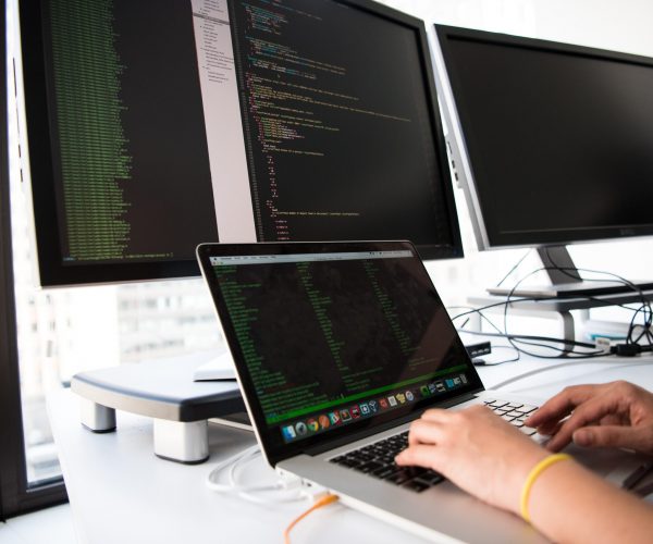 Coder writing on multiple screens